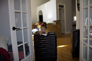 sitting girl moving luggage for shipping container