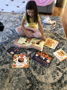 Little girl sitting deciding how to ship stuff like books international in shipping container