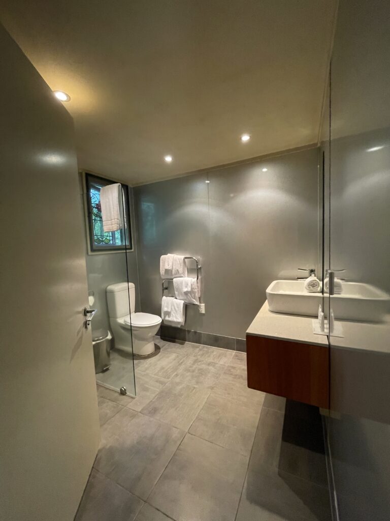 large bathroom in the room at Awaroa Lodge