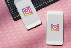 two white mobile phones with instagram logo on them
