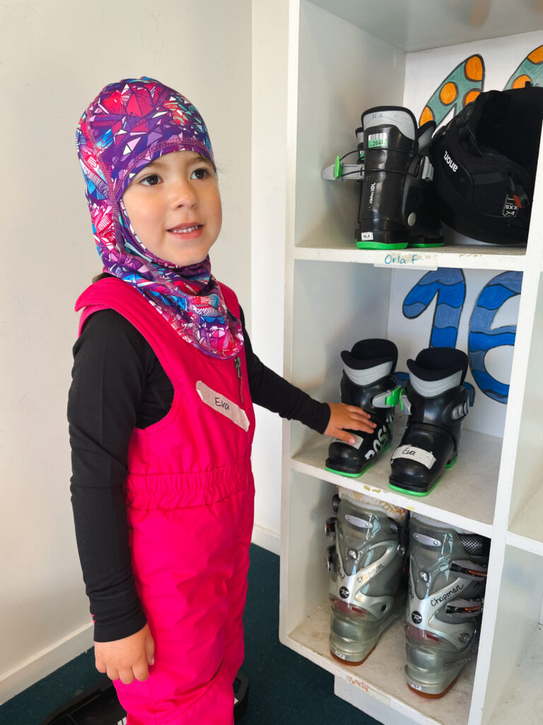 little girl showing ski boots at New Zealand ski resort