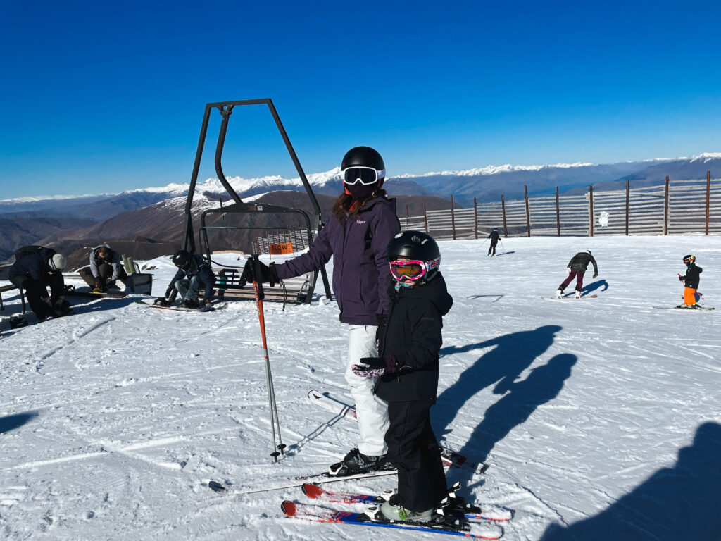 Mother and daughter wearing ski gear on ski slopes at the cardrona ski field