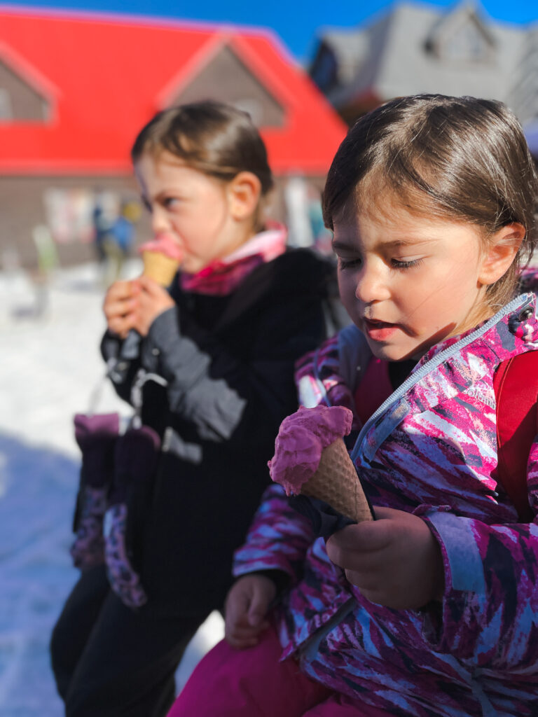 two little girls eating gelato after skiing on the cardrona ski field